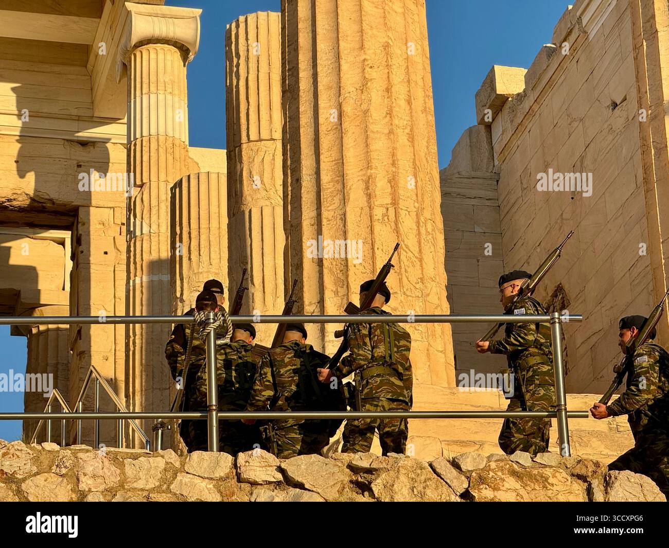 Das griechische Militär führt bei Sonnenuntergang eine Zeremonie durch, um das Innere der Akropolis zu besichtigen und die Flagge zu bewachen, eine wichtige kulturelle Tradition. - Smartphone-aufgenommenes Stockfoto