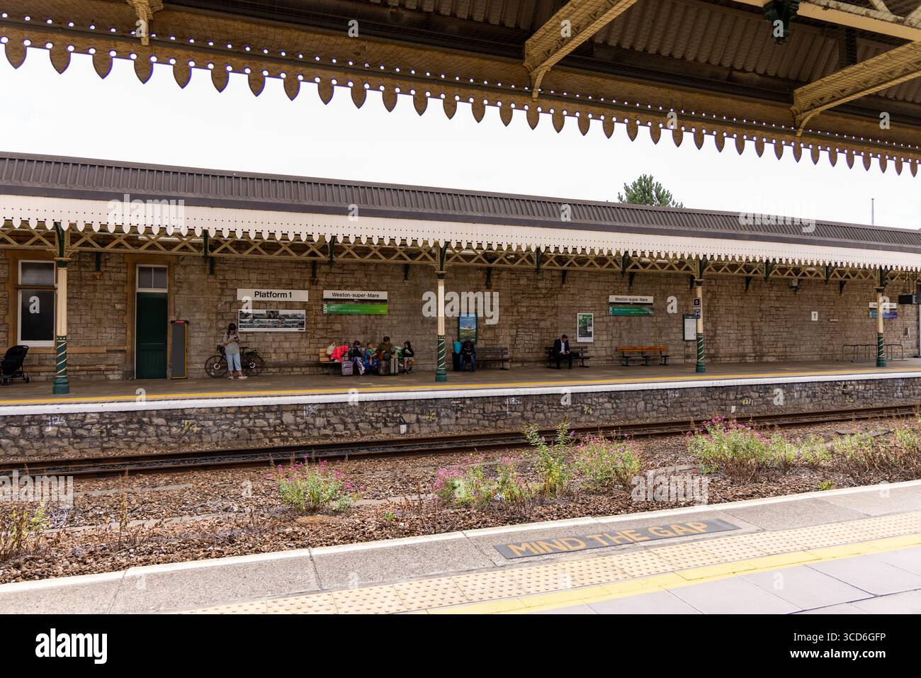 WESTON, Großbritannien - 8. AUGUST 2025 - Touristen warten auf Transport am Bahnsteig Weston super Mare, Somerset, England Stockfoto