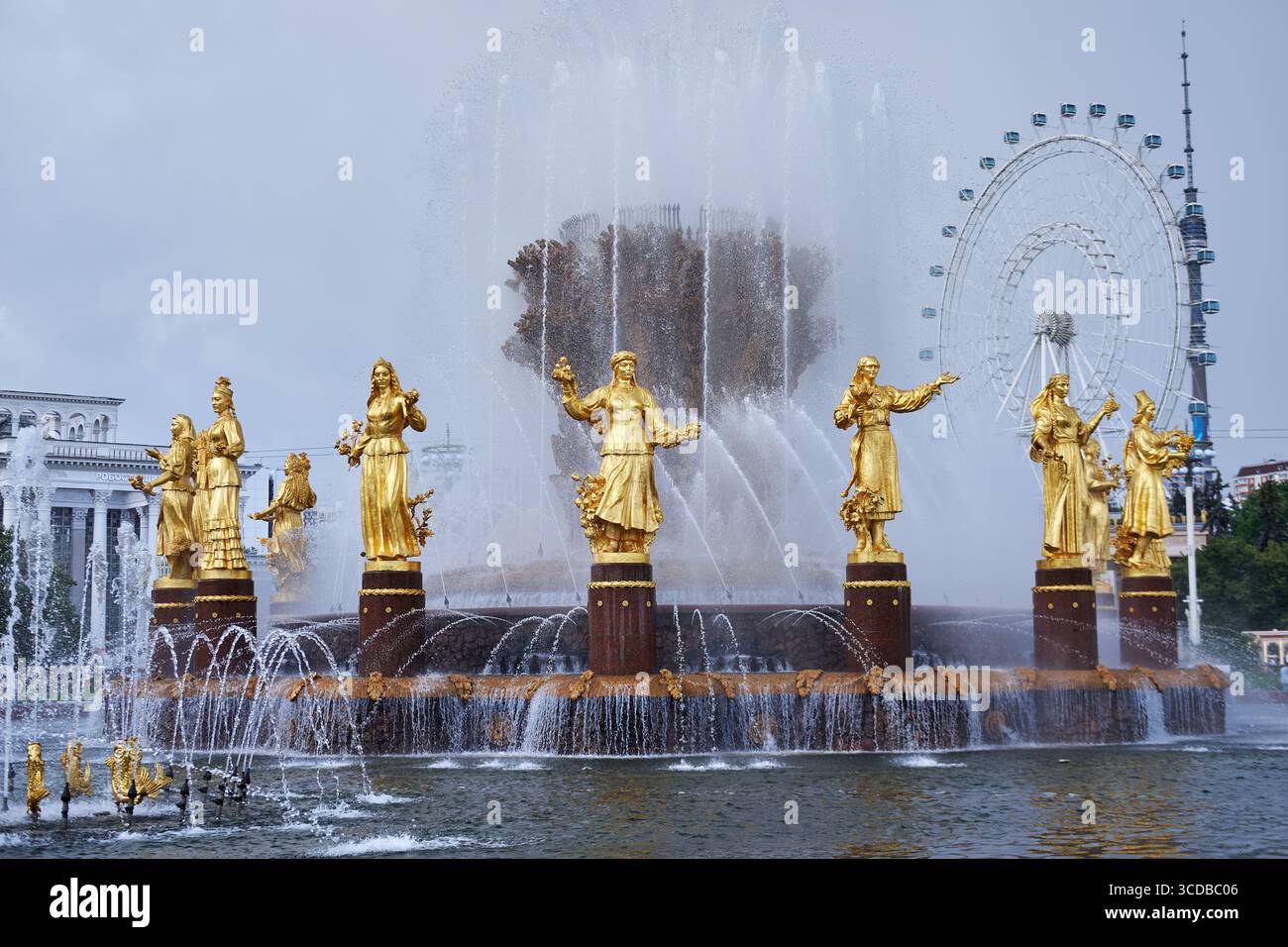 Moskau, Russland - 17. Juli 2025: Freundschaftsbrunnen der Völker bei VDNKh mit vergoldeten Figuren, Riesenrad und Ostankino-Turm Stockfoto