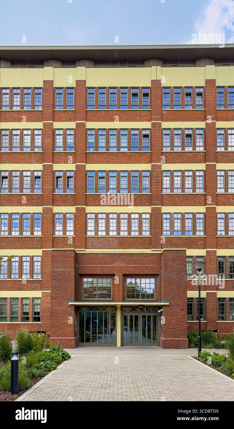 Die Cocoa Works Apartments, eine restaurierte ehemalige Schokoladenfabrik von Rowntree in York, mit rotem Ziegelstein, großen Industriefenstern und einer Landschaftsgestaltung Stockfoto