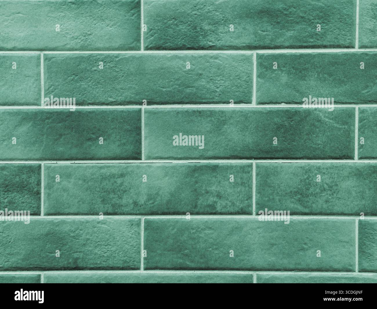 Grün gekachelter Hintergrund - strukturierte Wandgestaltung für digitale Hintergründe, minimalistische Ästhetik, Social Media-Grafiken und kreative Projekte in Werbung, Webdesign und modernen Innenraumdekorationslösungen Stockfoto