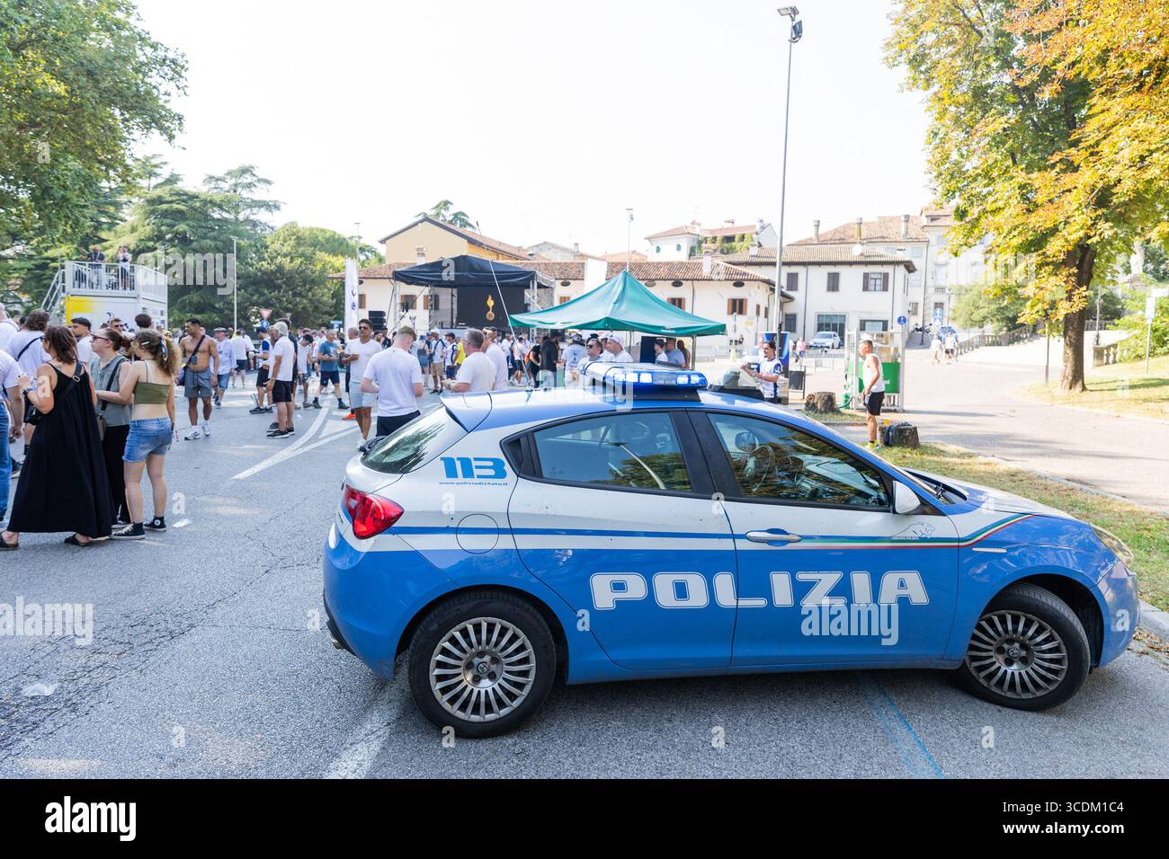 Udine, Italien, 13. August 2025: Polizeiauto parkt im Stadtzentrum von Udine und garantiert Sicherheit, da Fans Zeit vor dem Super Cup-Spiel genießen. Stockfoto