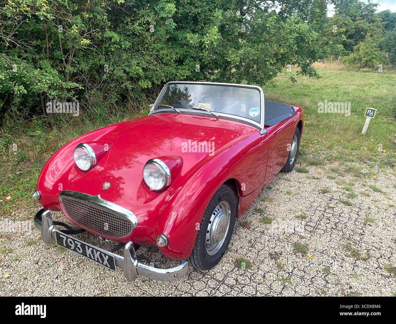 Austin Healey Sprite Cabriolet alter Stil 1959 britisches sportliches Fahrzeug rot hübsches Aussehen Oldtimer Scheinwerfer großes Design UK - Smartphone-aufgenommenes Stockfoto