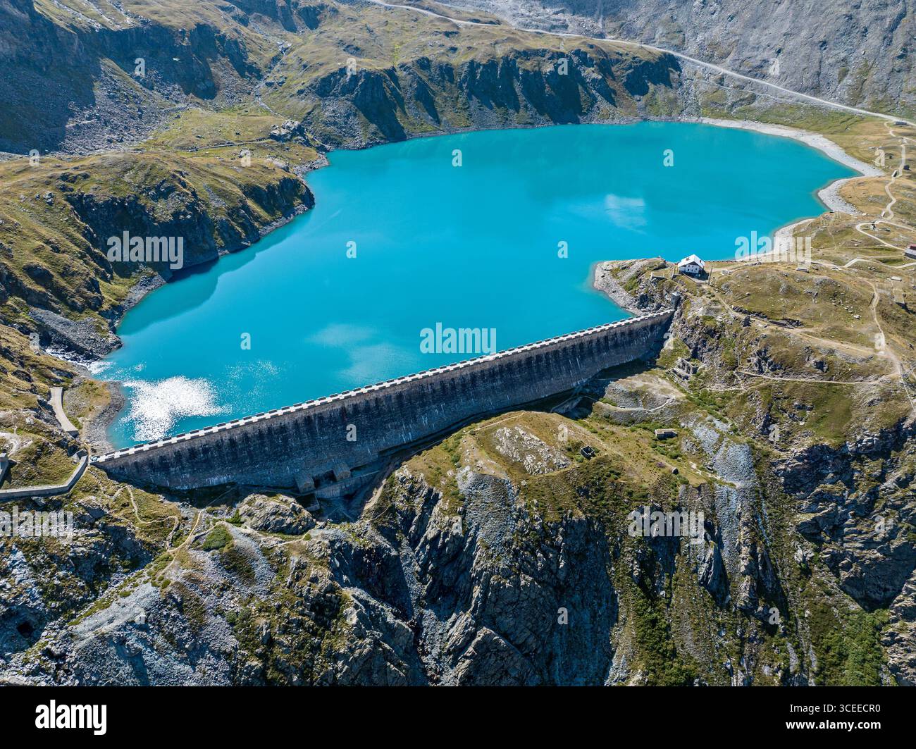 Blick aus der Vogelperspektive auf den Goillet-Stausee und Damm, in der Nähe von Matterhorn und Breuil-Cervinia. Grüne Täler und Wasserstraßen, die von den Gletschern fließen. Italien Stockfoto