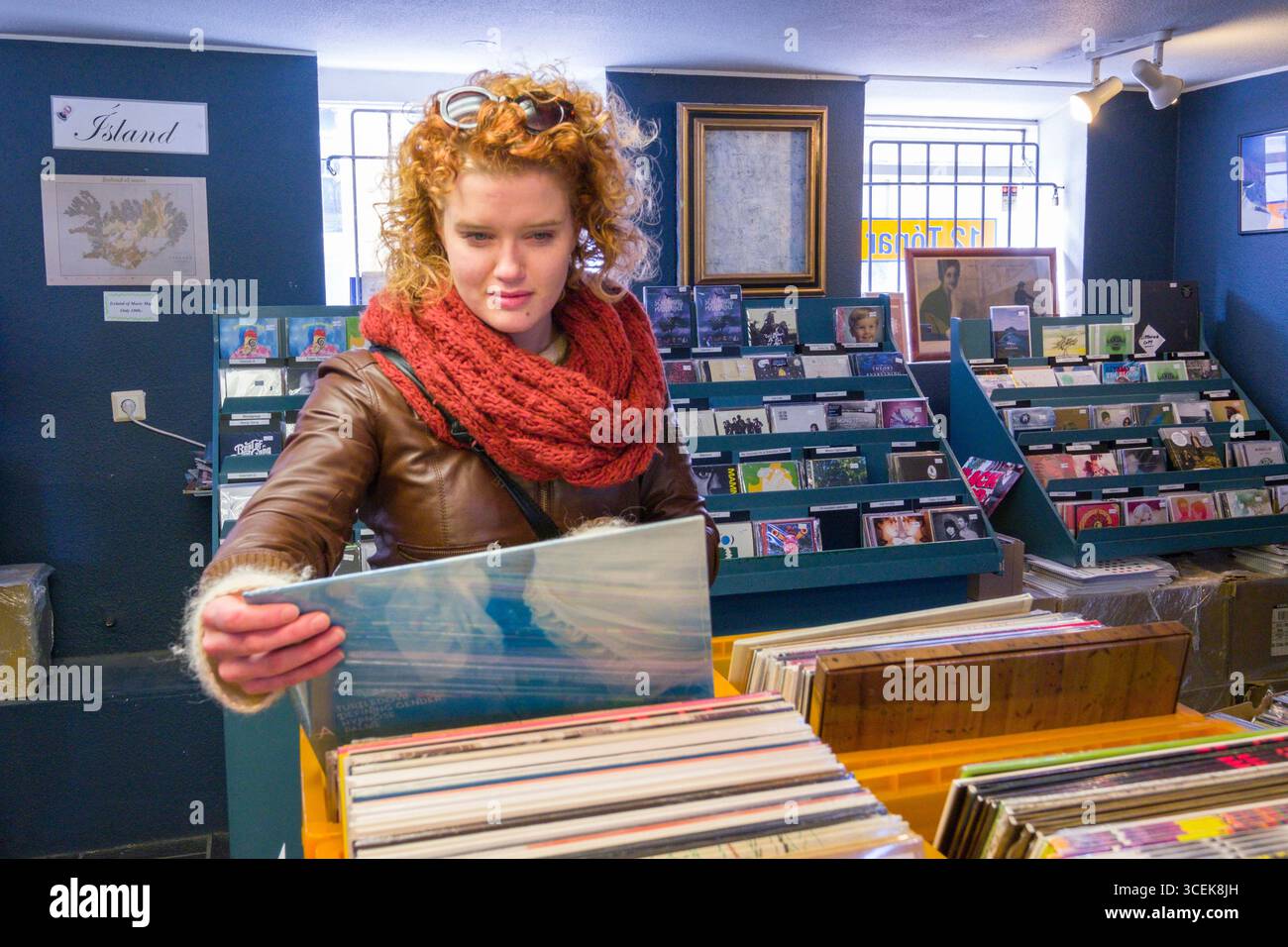 Junge Frau betrachten isländische Musik Schallplatten zum Verkauf innerhalb 12 Tónar Plattenladen, Skólavörðustíg, Miðborg, Reykjavík, Island Stockfoto