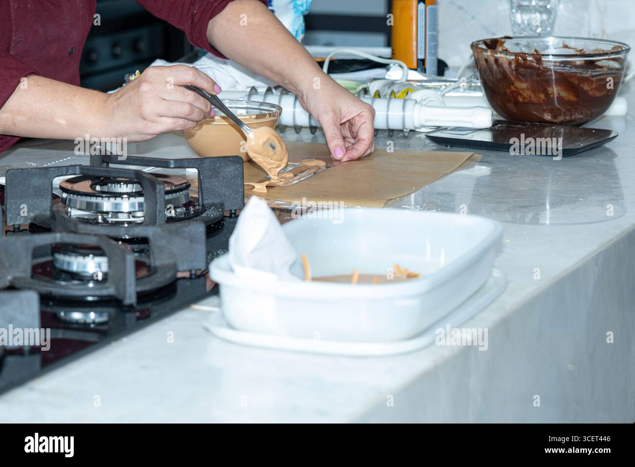 Der Koch macht eine zarte Dekoration mit Karamellschokolade. Stockfoto