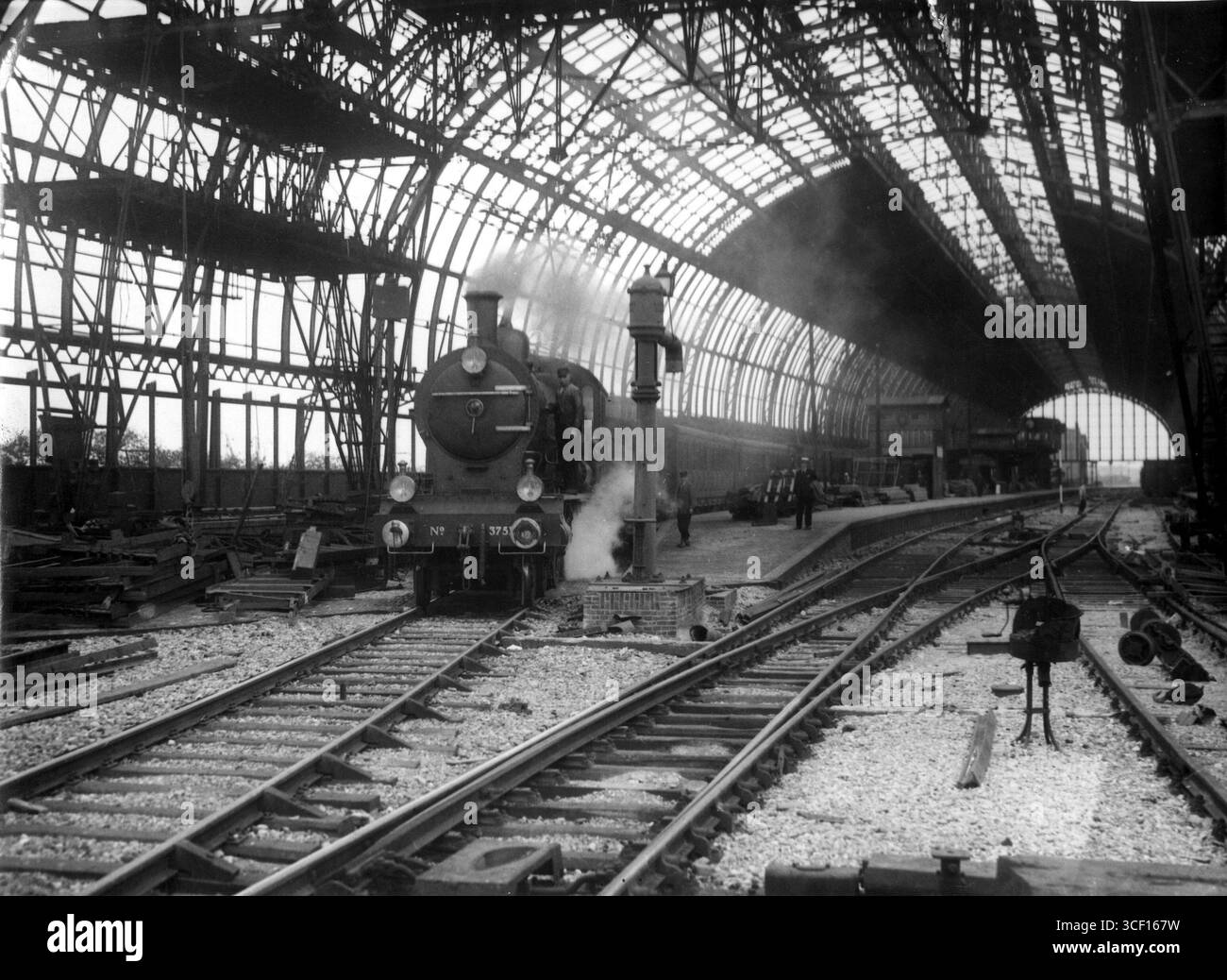 Dieses Bild aus dem Jahr 1924 zeigt den ersten Dampfzug, der vom neuen Bahnhof am Amsterdamer Hauptbahnhof abfährt. Die Entwicklung war ein bedeutender Meilenstein bei der Modernisierung des Bahnhofs und der Eisenbahninfrastruktur des Landes. Stockfoto