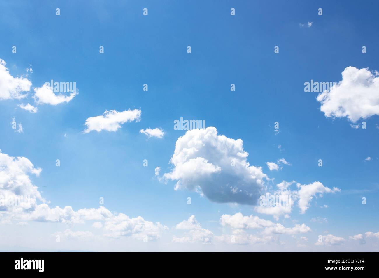 Weiße flauschige Wolken am azurblauen Himmel. cumulus-Wolkenlandschaft im Sommer bei hellem Licht. Wetter Hintergrund für Urlaub an einem sonnigen Tag. Trübe Atmosp Stockfoto