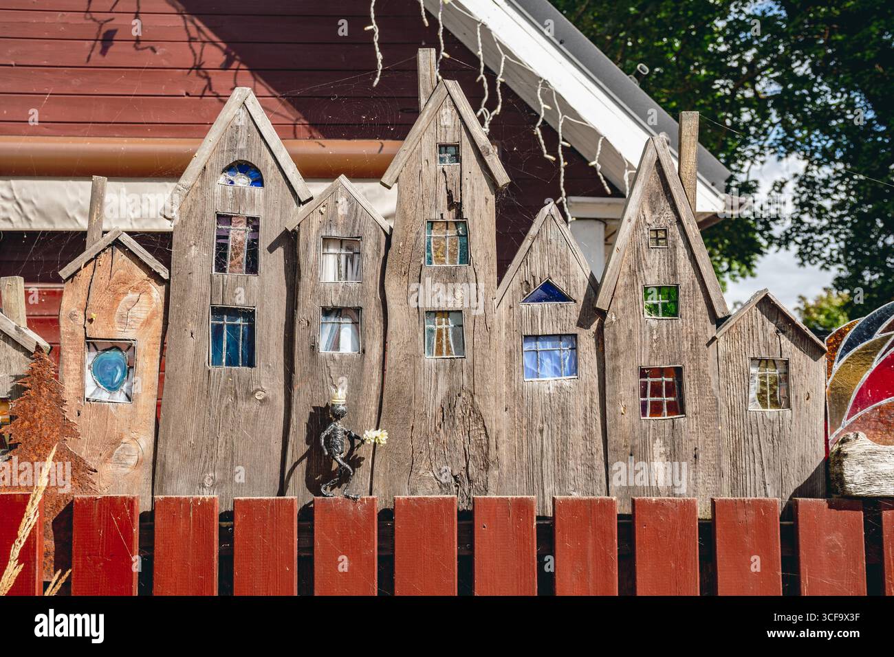 Bezauberndes rotes Holzhaus mit dekorativem Zaun in einer malerischen Gegend in Haapsalu, Estland, Europa Stockfoto