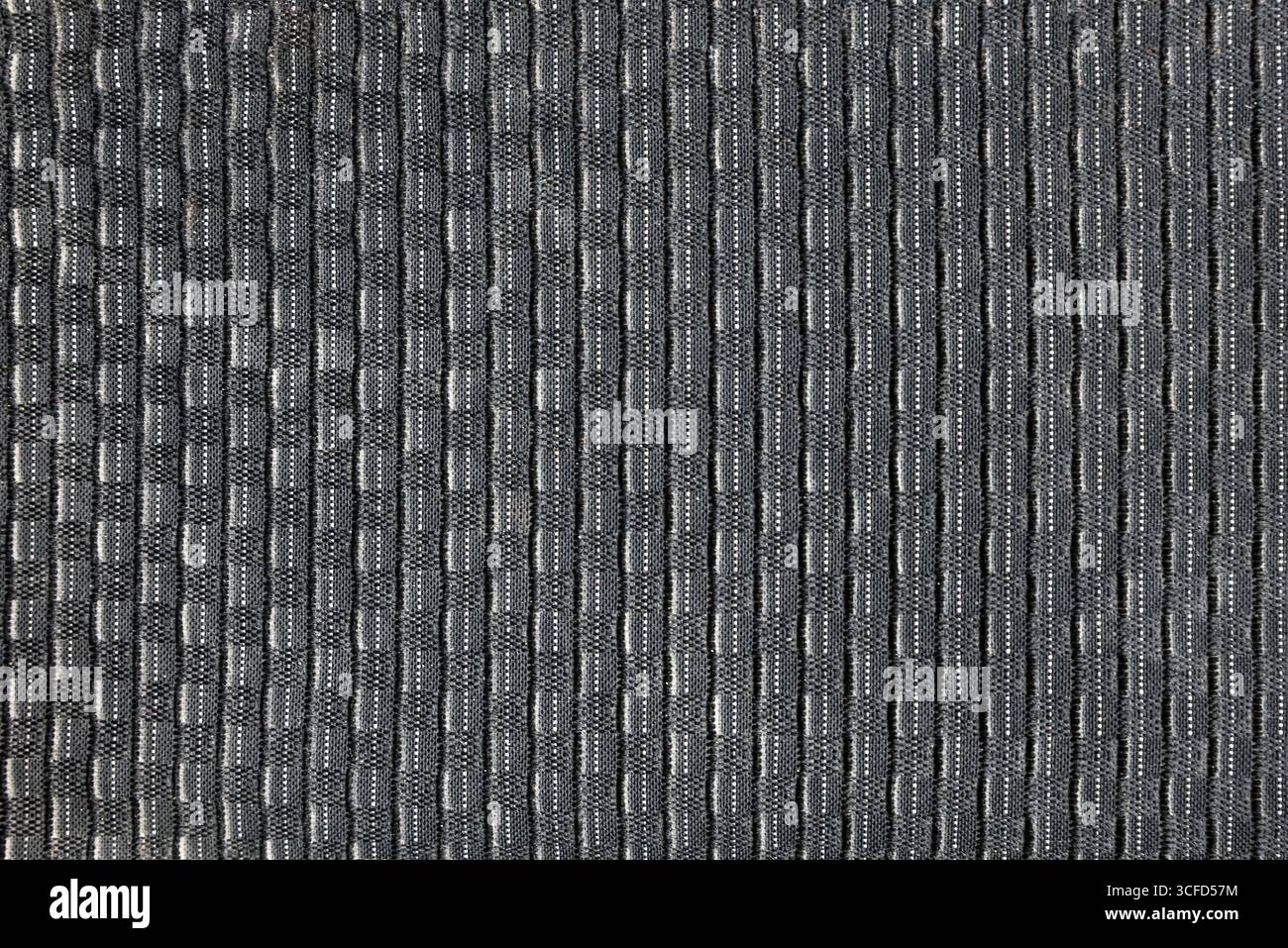 Strukturierter Hintergrund des grauen Teppichs, gesprenkelt mit vertikalen Linien in grauen Blöcken. Draufsicht. Stockfoto