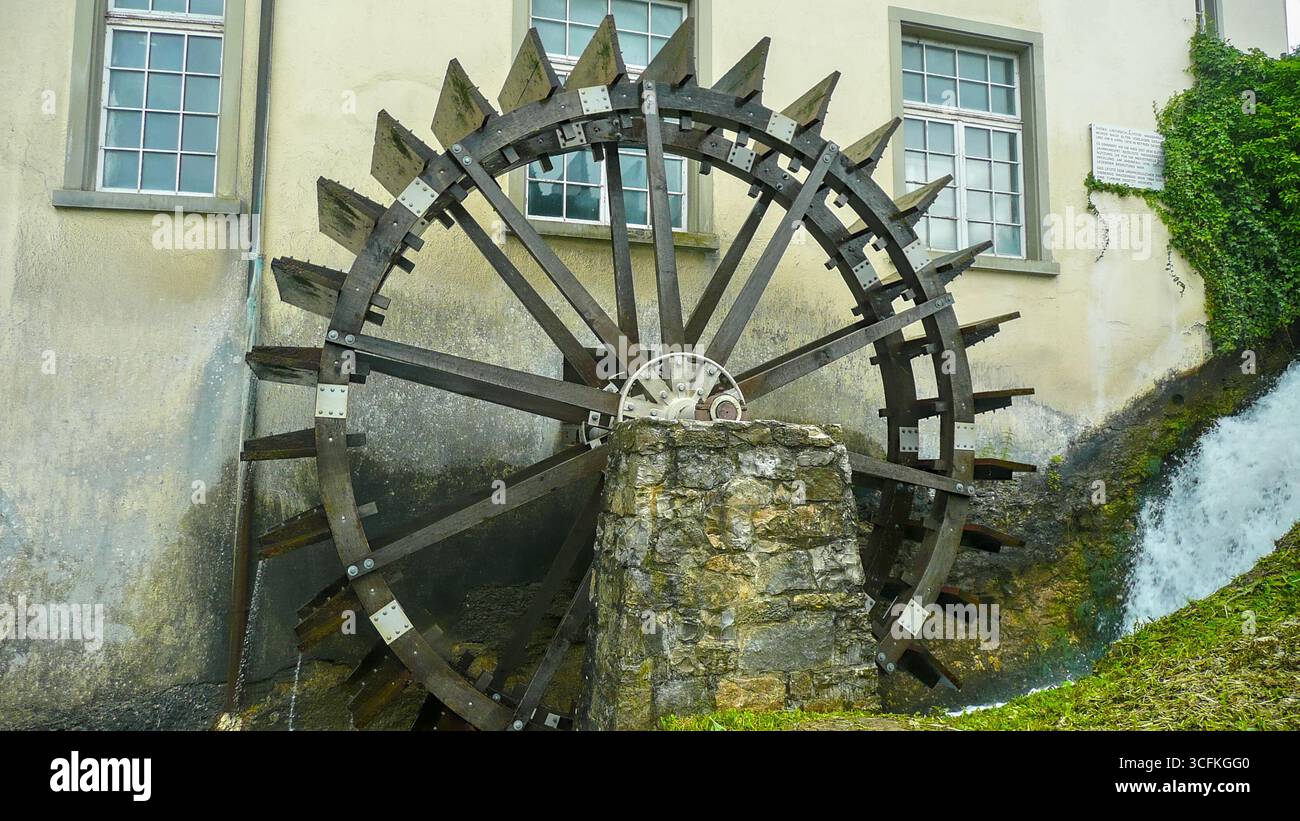 Altes hölzernes Wasserrad einer traditionellen Wassermühle – historische Technologie mit fließendem Wasser, Symbol für Erbe und ländliche Handwerkskunst. Stockfoto