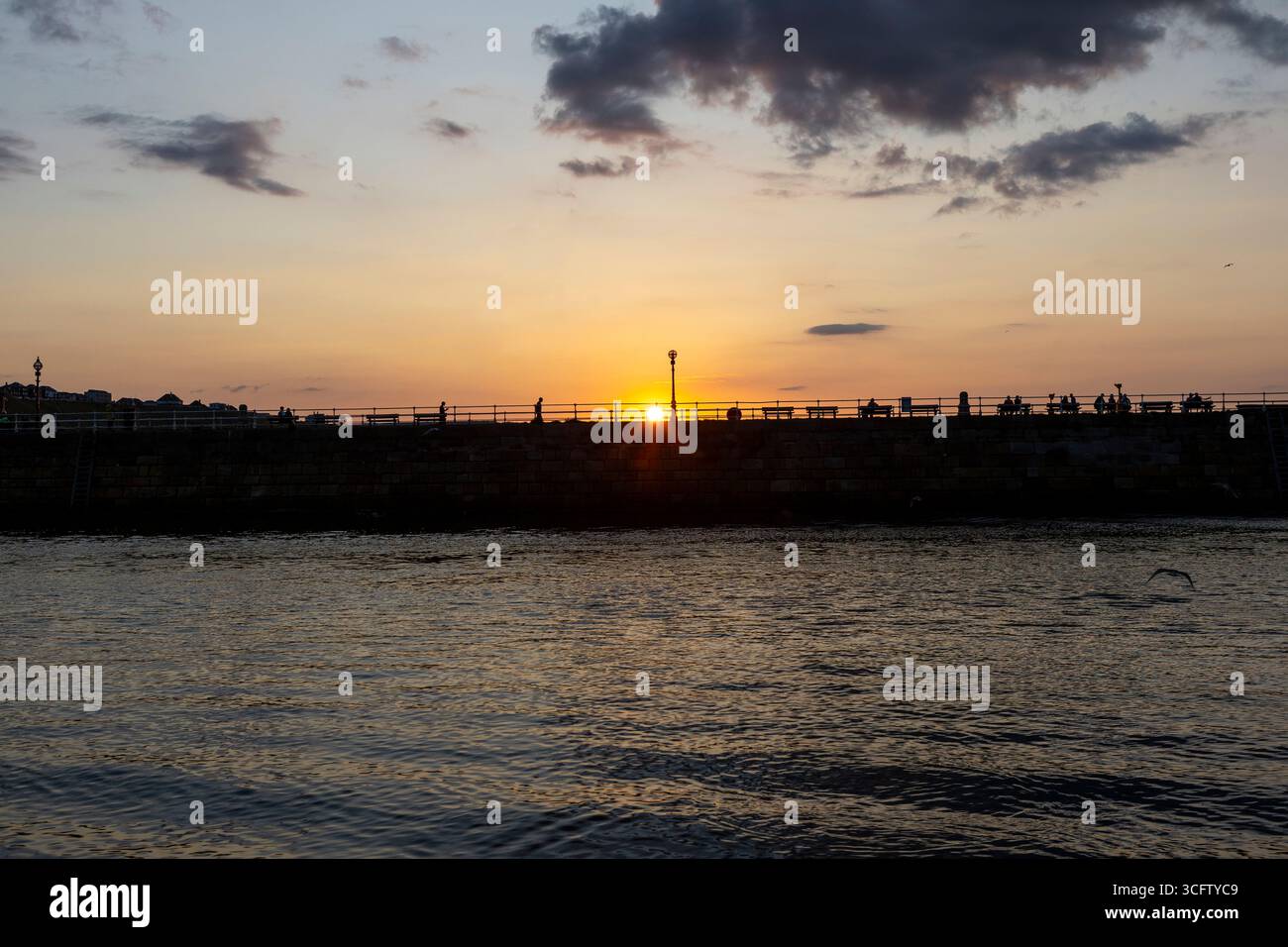Whitby Pier bei Sonnenuntergang an einem Sommerabend Stockfoto
