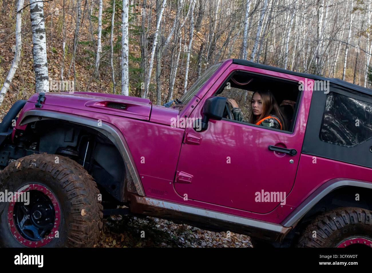 Junge Frau parkt Jeep im Wald, Biwabik, Minnesota, USA Stockfoto