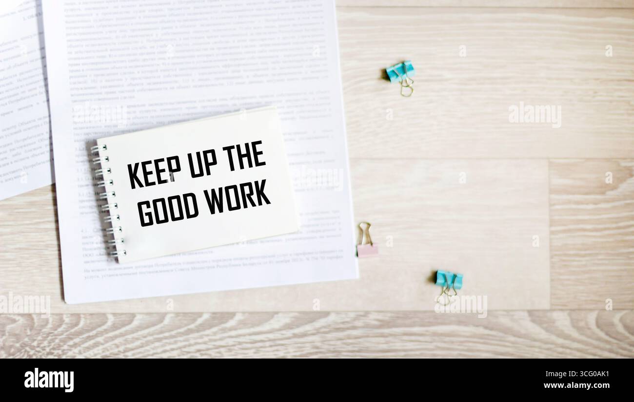 Ein Notizbuch mit der Aufschrift „Keep up the good work“ auf hellem Hintergrund Stockfoto