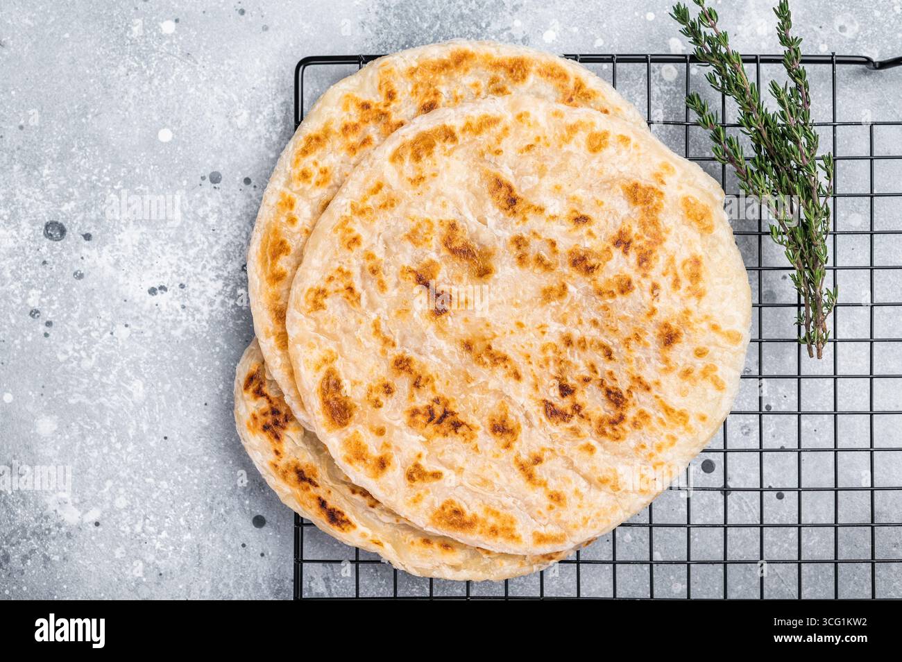Hausgemachte Kerala-Weizen-Paratha, geschichtete Parotta. Grauer Hintergrund. Draufsicht. Stockfoto