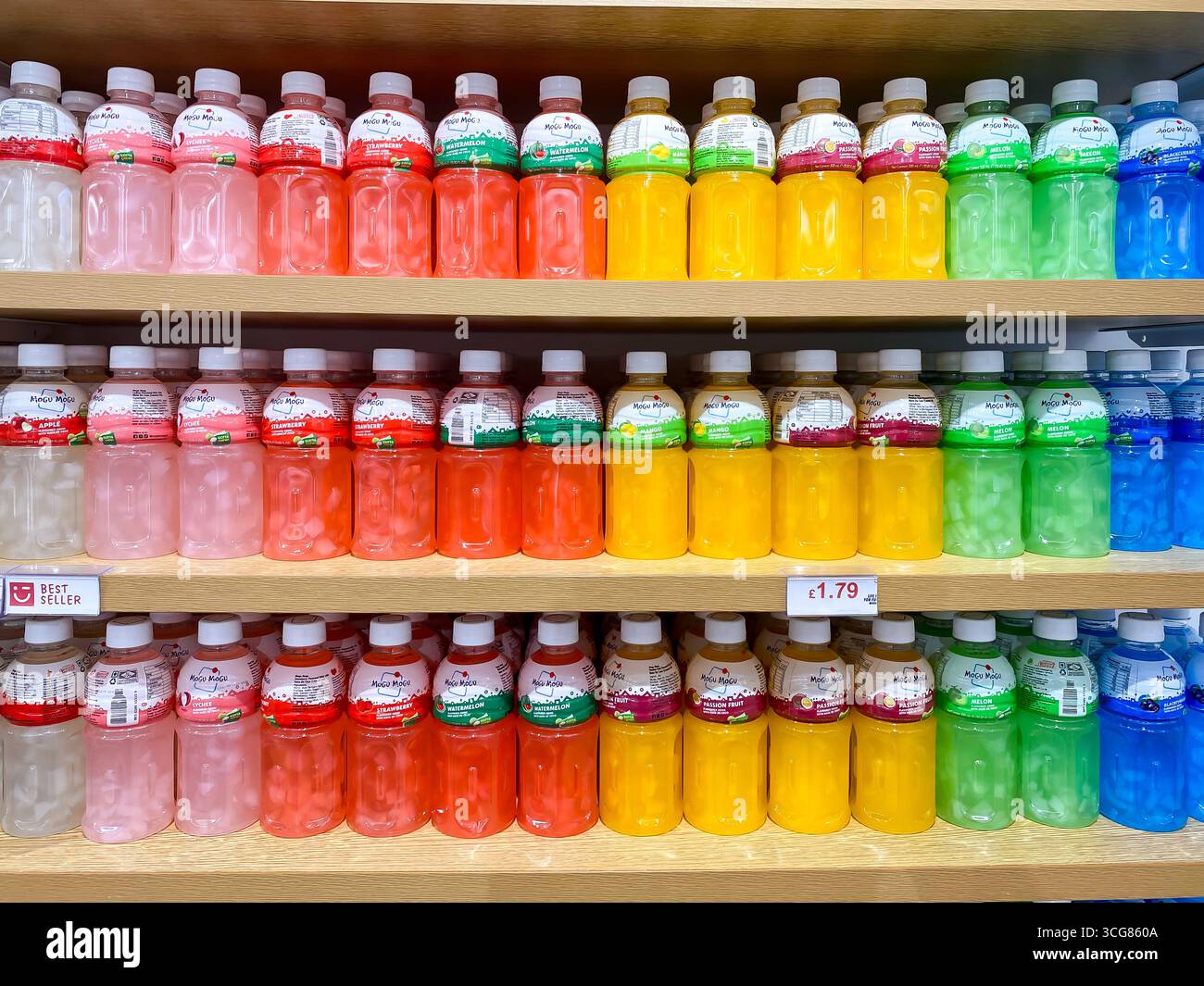 Farbenfrohe Flaschen von Mogu Mogu, einer Marke mit Fruchtgeschmack, mit Stücken Nata de Coco (Kokosgelee), die in den Regalen in einem Geschäft ausgestellt werden. - Smartphone-aufgenommenes Stockfoto