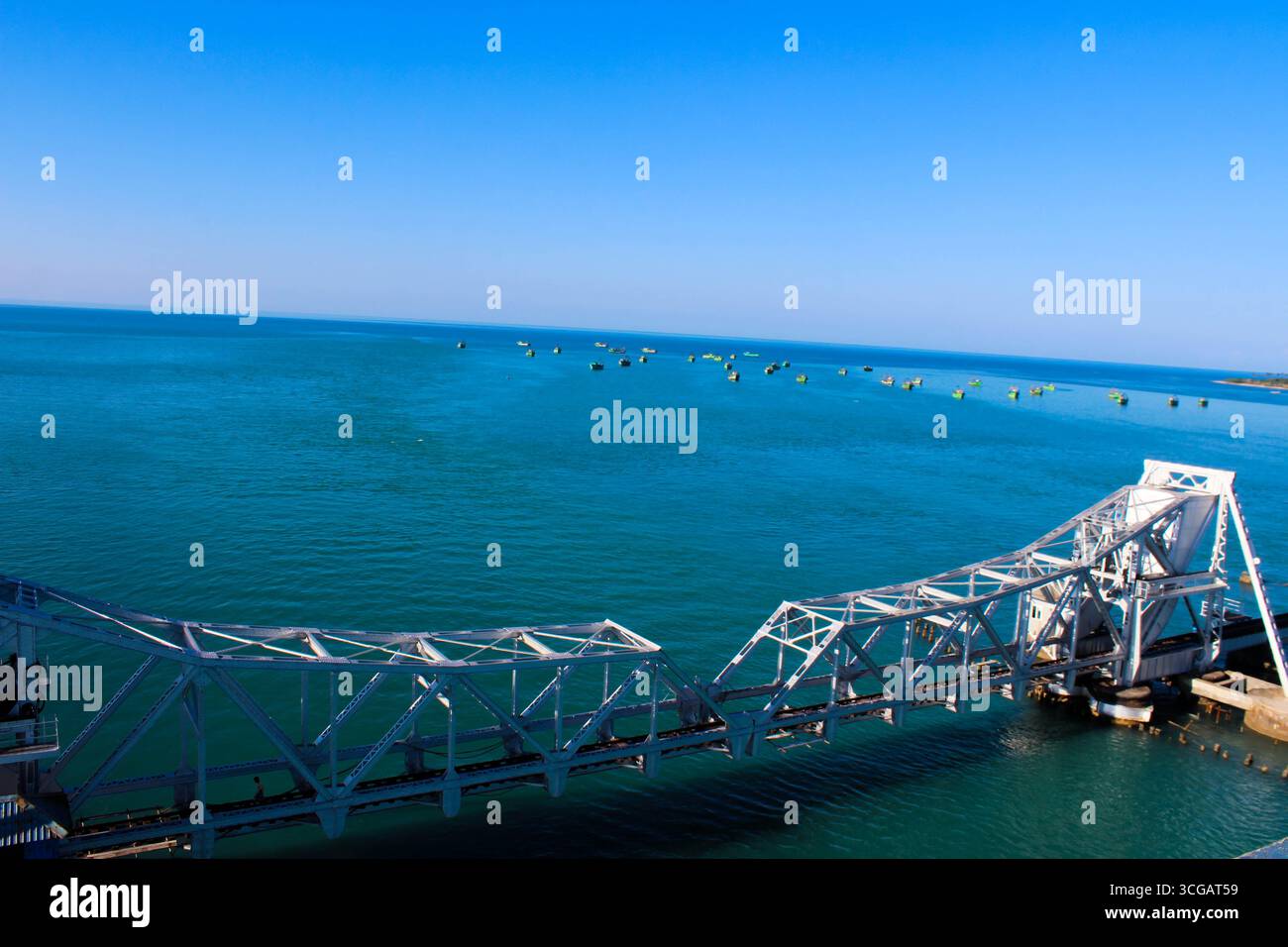 Auf dem Weg nach Dhanuschkodi führt eine enge Straße, die vom Meer flankiert wird, zu den eindringlichen Ruinen der Geisterstadt, die einen atemberaubenden Blick auf das Meer und die Geschichte bietet. Stockfoto