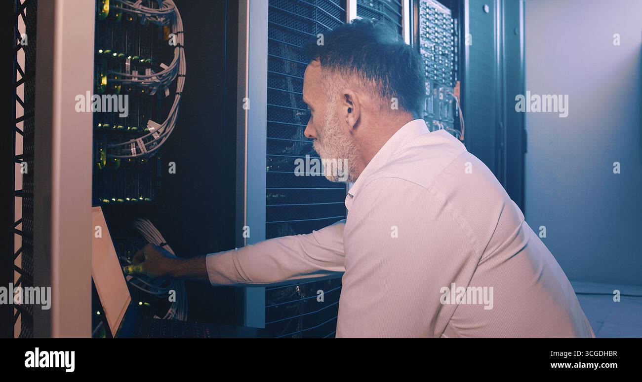 Techniker, Laptop- und Kabelanschluss im Rechenzentrum für Netzwerktests, Fehlerbehebung oder Lösungen. Erfahrene Person, Inspektion oder Technologie im Server Stockfoto