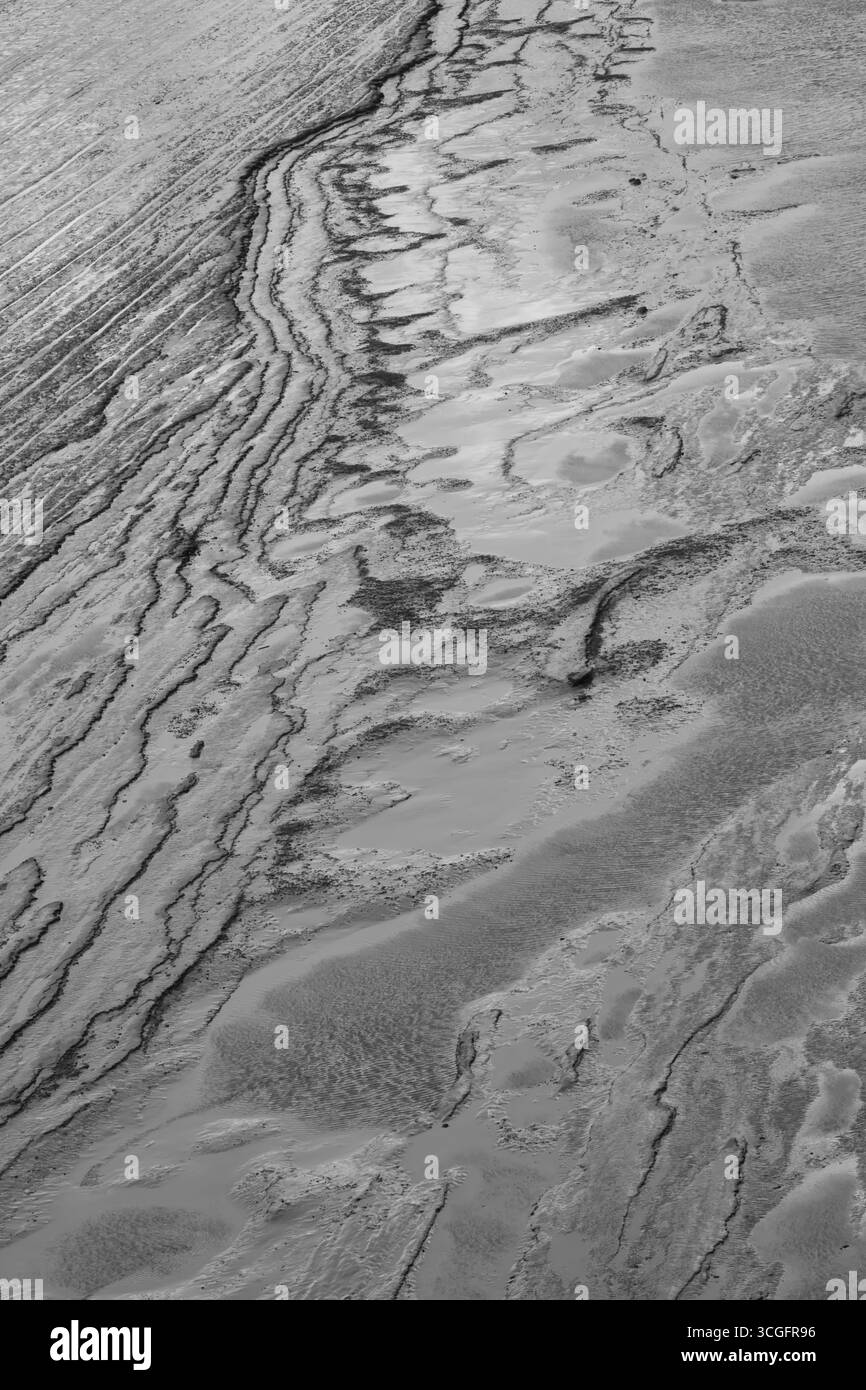 Muster im Wattenmeer des Humber Estuary, North Lincolnshire, einfarbig bei Ebbe Stockfoto