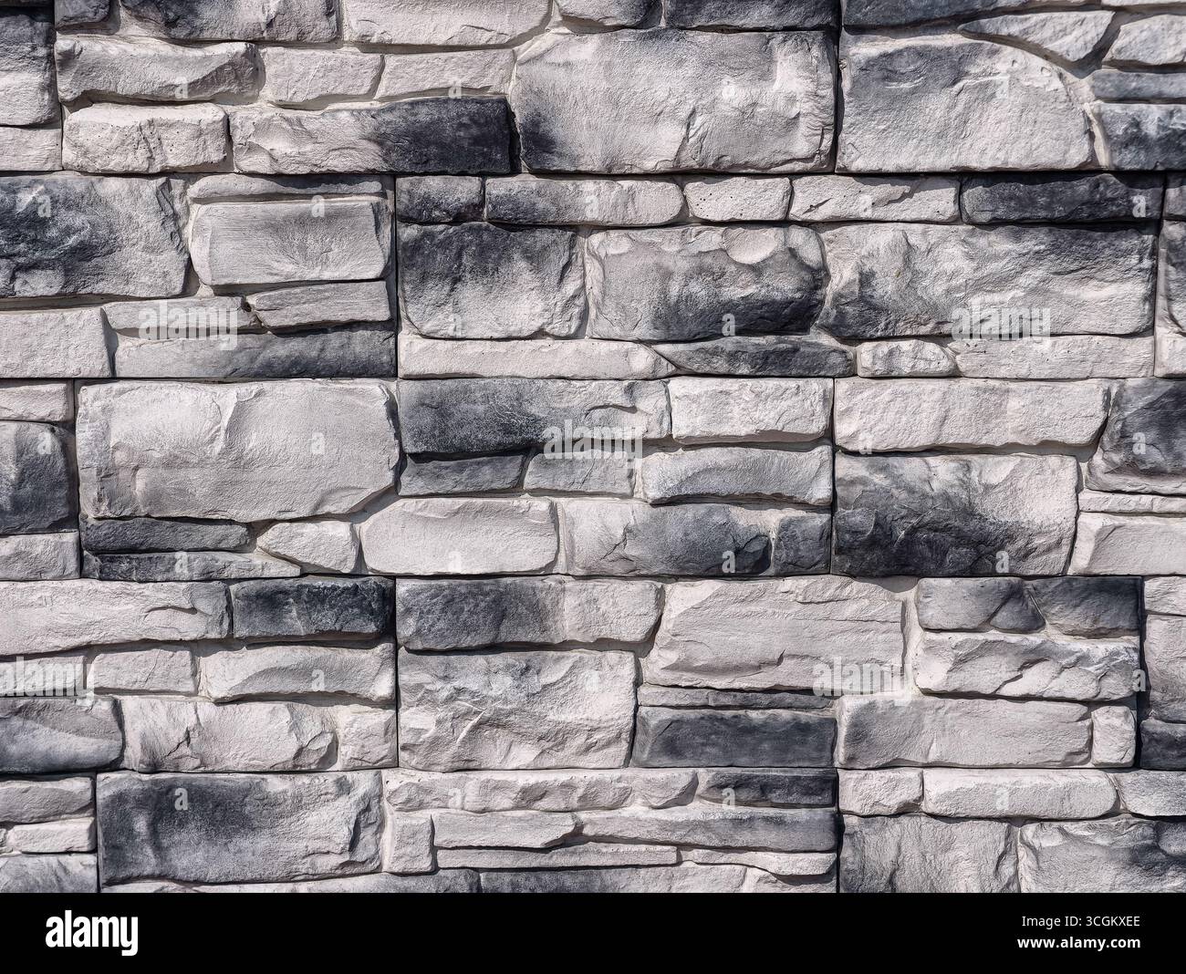 Hochauflösende graue Steinwand-Textur für Architekturdesign, digitale Hintergründe, Fotografie, minimalistisches Webdesign, Wohnkultur, und effektives Marketingmaterial in verschiedenen Branchen Stockfoto