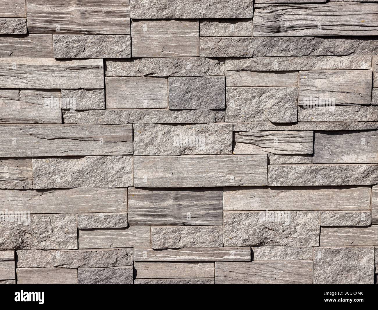 Steinwand-Textur: Hochauflösender grauer strukturierter Hintergrund für digitale Hintergründe, minimalistische Designs, Fotografie, Webdesign, Marketingmaterialien, und kreative Werbeaktionen in allen Branchen Stockfoto
