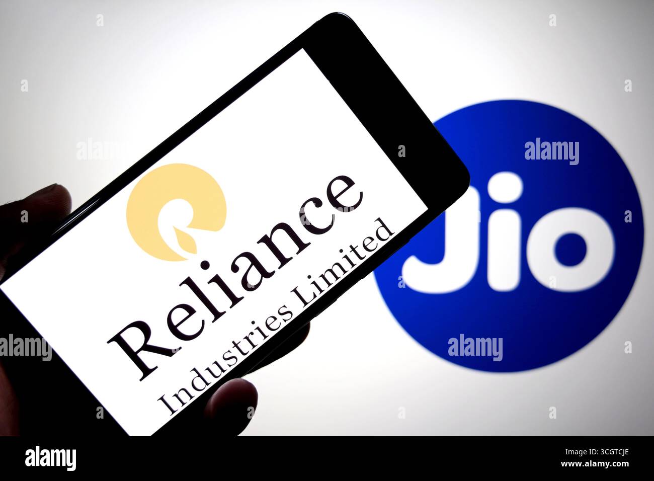 In dieser Fotoabbildung ist das Relinace Industries Logo auf einem Smartphone mit einem Reliance Jio Logo im Hintergrund zu sehen. Stockfoto