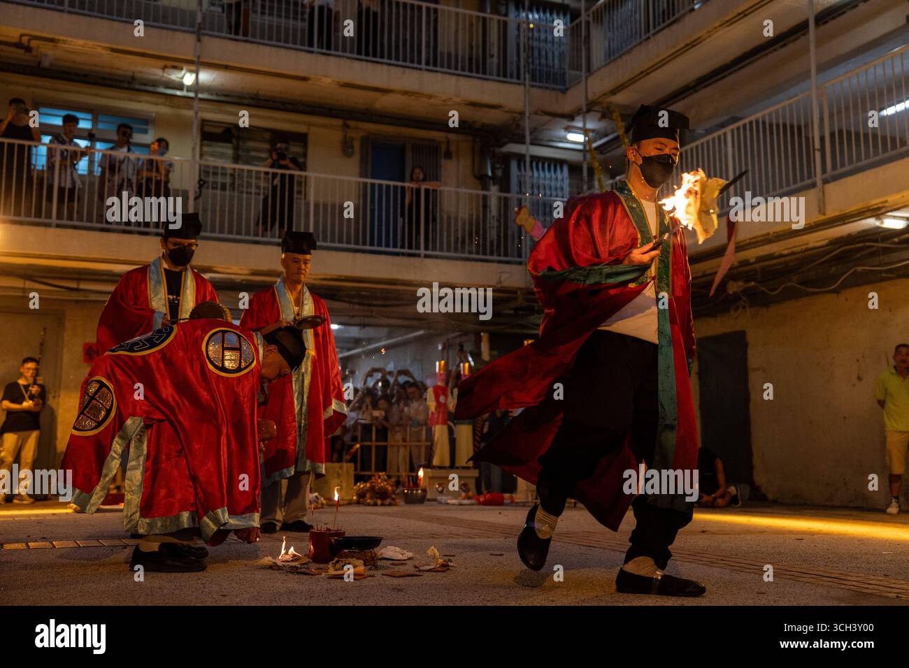 Hong Kong Ghost Festival in Public Housing Estate Ein taoistischer Priester, der am 31. August 2025 in Hong Kong Ein Schwert in Flammen hält, während er das Break Hell s Gate oder das letzte Tanzritual beim Geisterfestival im Wah Fu Estate vorstellt. Foto von Vernon Yuen/Nexpher Images Stockfoto