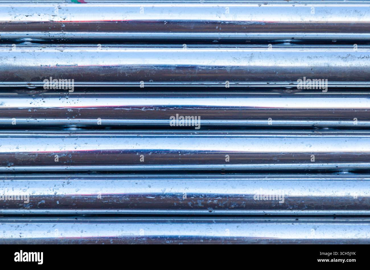 Hintergrund aus neuen horizontalen Aluminiumrohren, Nahaufnahme. Stockfoto