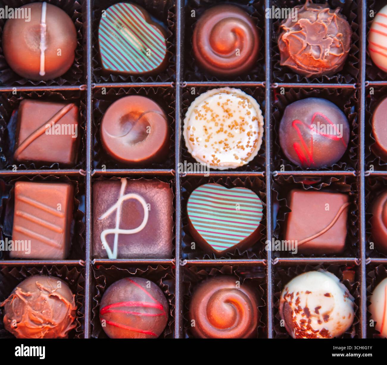 Elegante Schokoladenauswahl in einer Schachtel, perfekt für ein luxuriöses Geschenk. Genießen Sie den exquisiten Luxus einer Gourmet-Schokoladensammlung pro Person Stockfoto