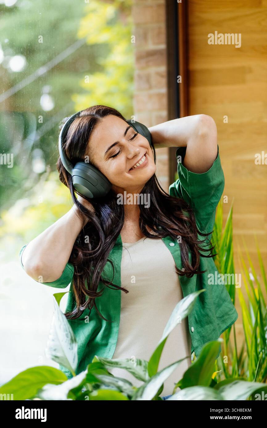Entspannte Frau, die Freizeit genießt und Musik hört. Stockfoto