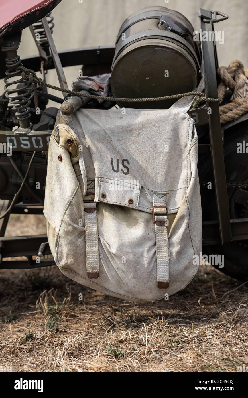 Die US-Militärtasche hängt an einem grünen alten Motorrad für die historische Nachstellung des Zweiten Weltkriegs Stockfoto