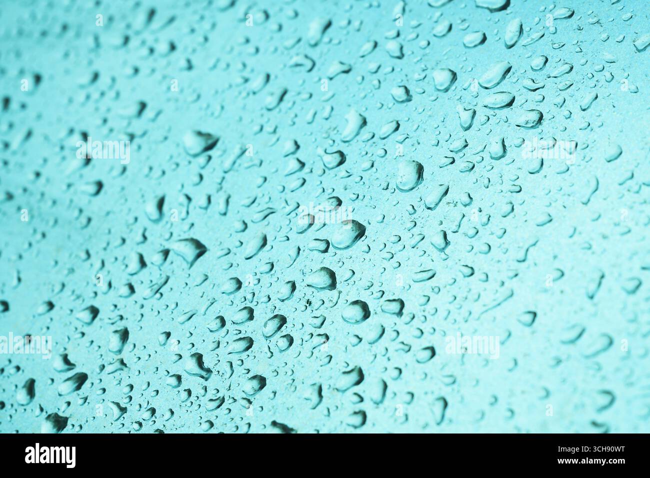 Regentropfen auf glatte metallische Oberfläche von Industrieobjekten, Wetter- und Klimakonzept, selektiver Fokus Stockfoto