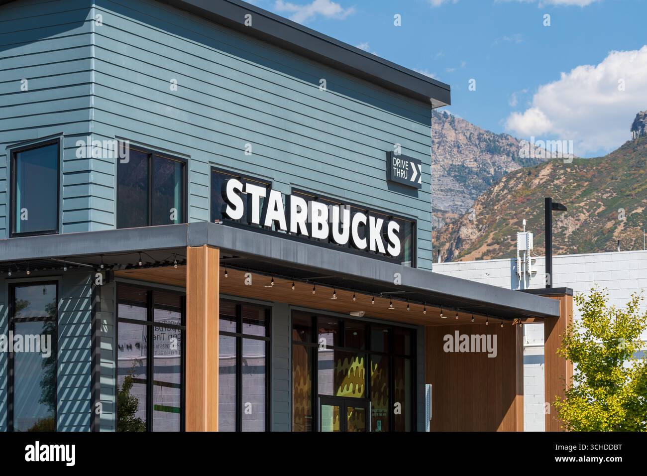 Provo, Utah, USA – 1. September 2025: Eine moderne Starbucks-Storefront bietet auffällige Schilder und klare architektonische Linien unter teilweise bewölktem Himmel. Stockfoto