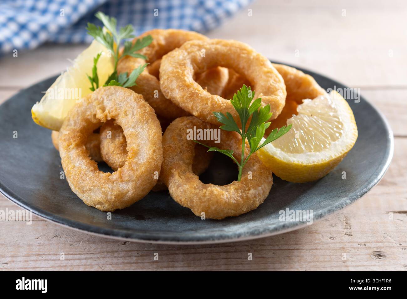 Nahaufnahme von knusprigen Calamari-Ringen, serviert auf Holztisch Stockfoto