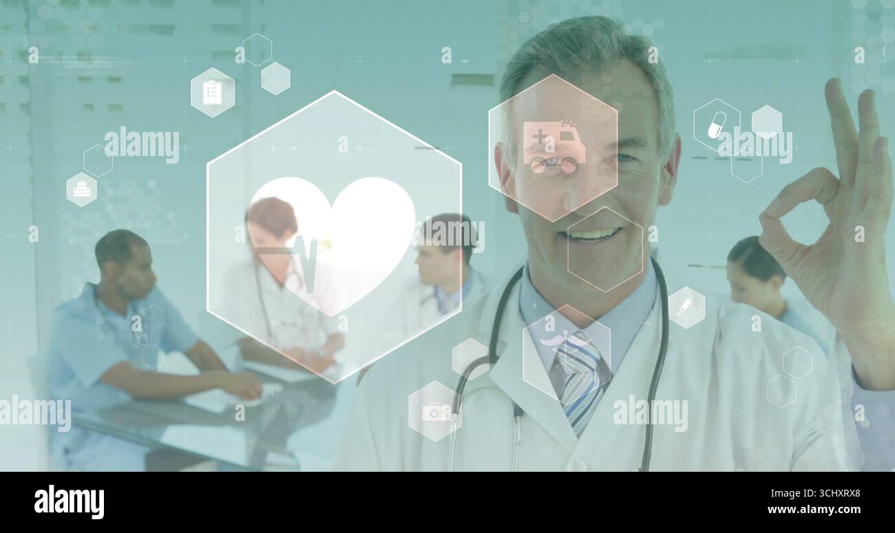 Gesten eines leitenden Arztes, der im Konferenzraum OK-Zeichen macht, mit Hexadezimalsymbolen, Stethoskop, Kopierraum Stockfoto