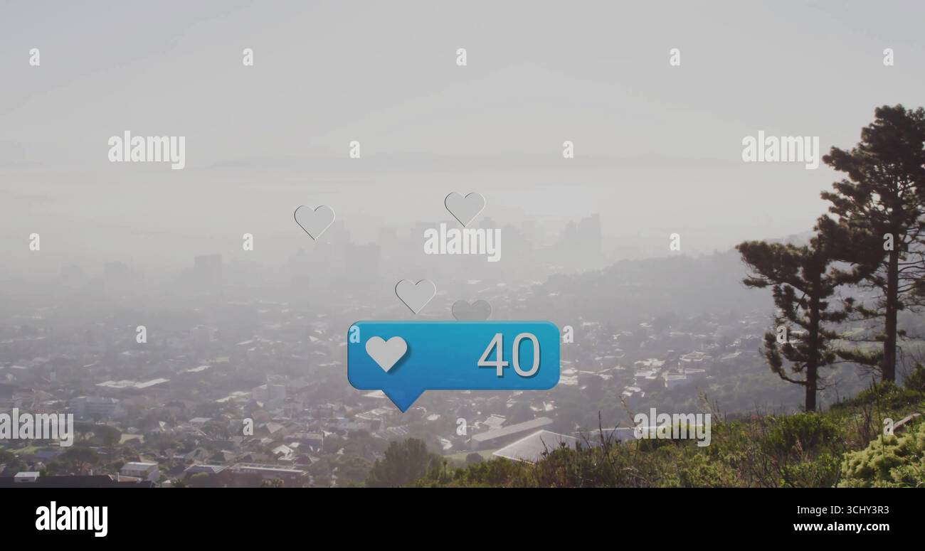 Schwebende blaue Benachrichtigungsblase mit Herzschlag auf nebeligen Berghängen in der Stadt, mit treibenden Herzen Stockfoto