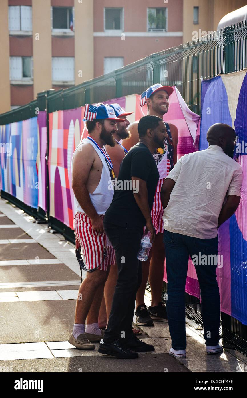 US-amerikanische Unterstützer, die während des Leichtathletikwettbewerbs in Stade de France während der Pariser Spiele 2024 durch einen Zaun schauen Stockfoto