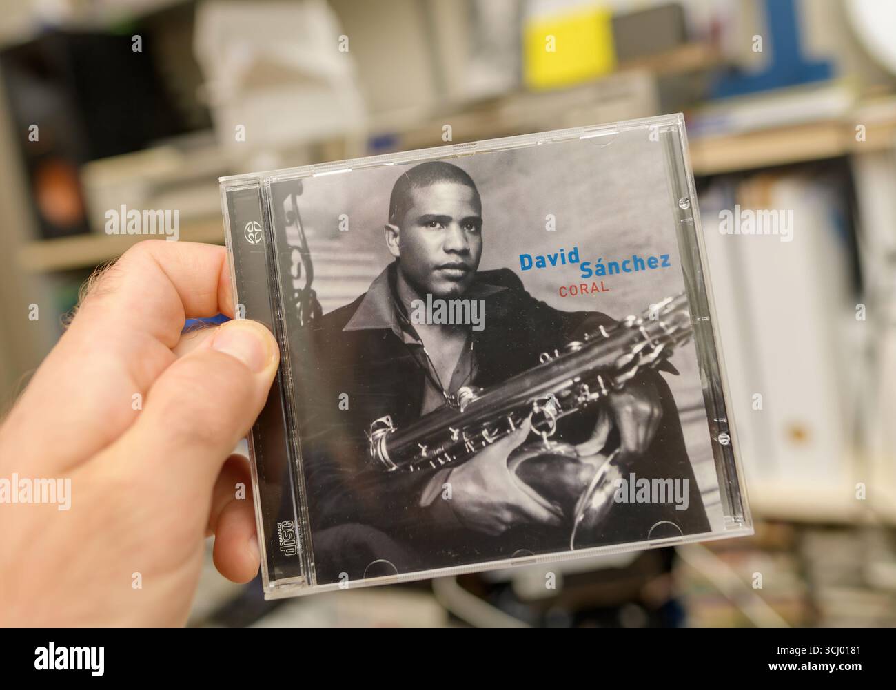 Paris, Frankreich - 21. Mai 2024: Nahaufnahme von SACD Coral von David Sanchez in einem Schmuckkästchen aus Kunststoff, das von Hand gehalten wird, mit Regalen und Ausrüstung, die in der Ba sichtbar sind Stockfoto