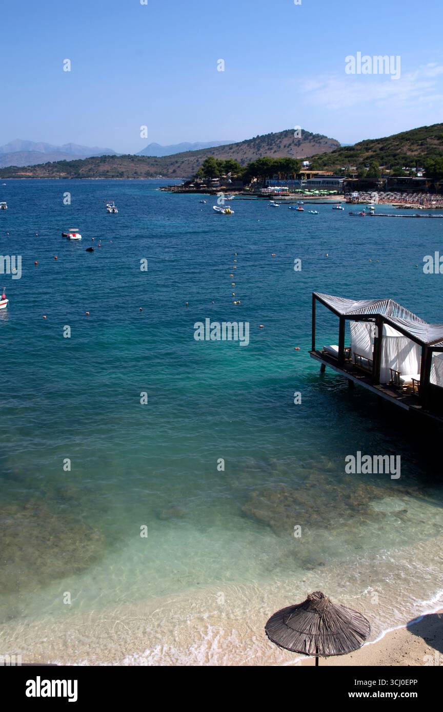 Pontile di prolungamento della spiaggia proteso sull'acqua limpida a Ksamil Stockfoto