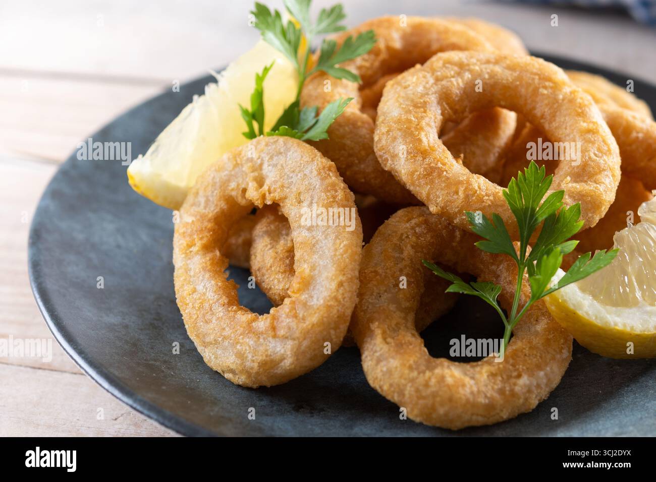 Knusprige gebratene Tintenfischringe auf Holztisch Stockfoto