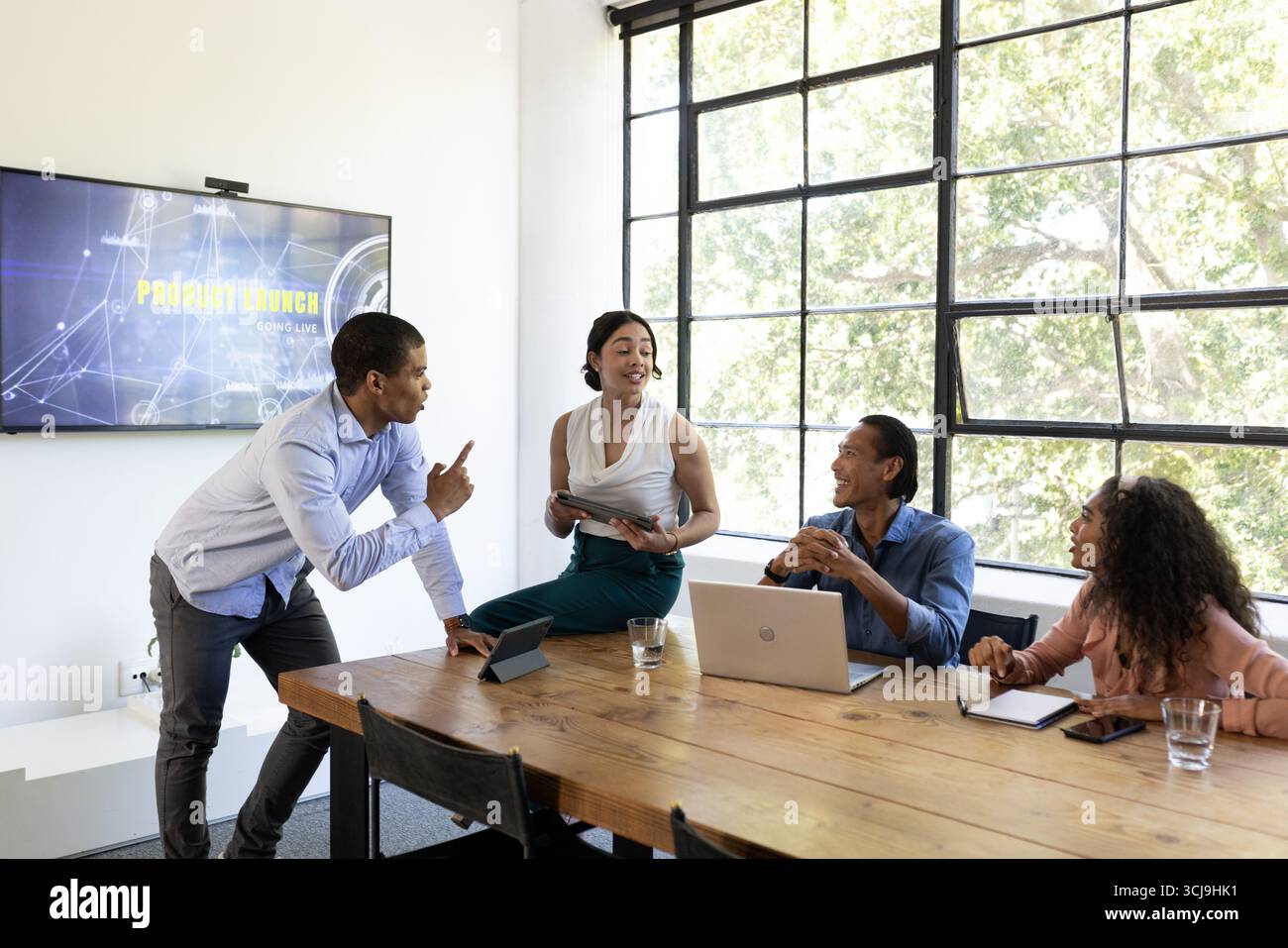 Verschiedene Geschäftsteams diskutieren Produkteinführungsstrategie im modernen Konferenzraum Stockfoto