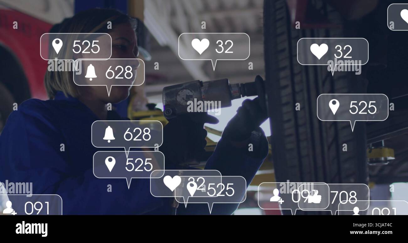 Mechaniker mit Handschuhen in Overalls löst Reifen mit Schlagschrauber am Garagenlift, Benachrichtigungssymbole Stockfoto
