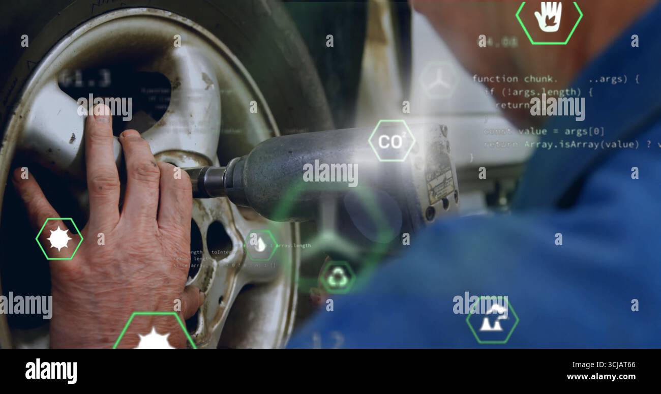 Festziehen der Radmuttern mechanisch in blauer Uniform mit Schlagschrauber am Rad in der Garage, Code-Grafiken Stockfoto
