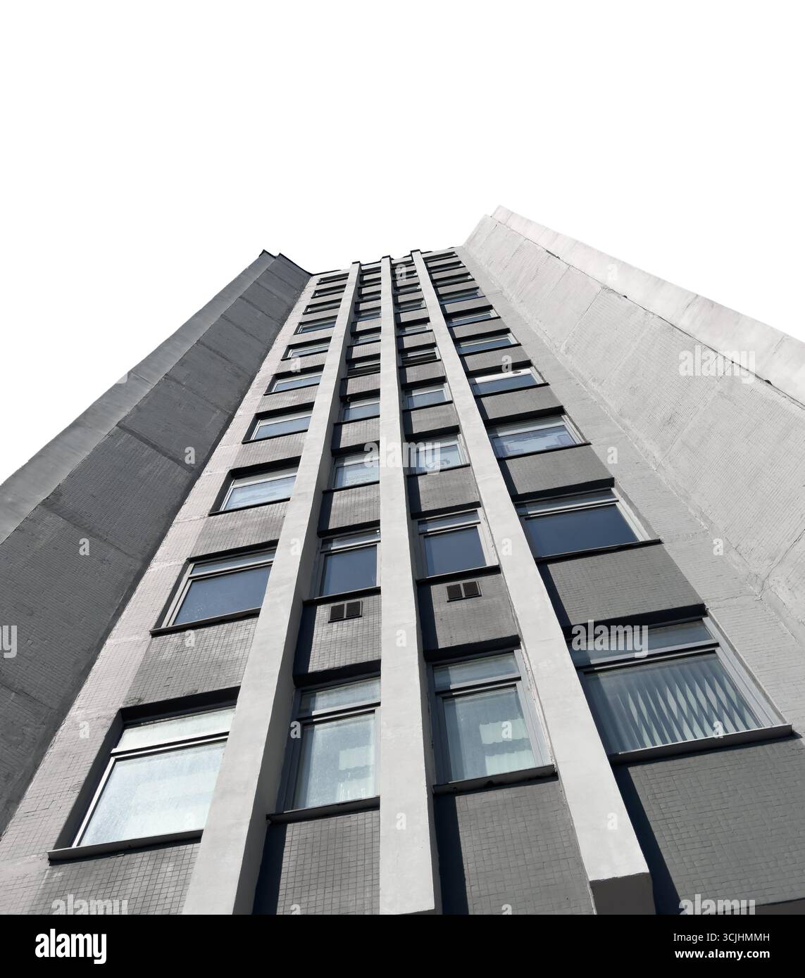 Blick nach oben auf ein modernes Wohnhochhaus mit sich wiederholenden Fenstern und klaren Linien, isoliert auf weißem Hintergrund. Die scharfe vertikale Perspektive hoch Stockfoto