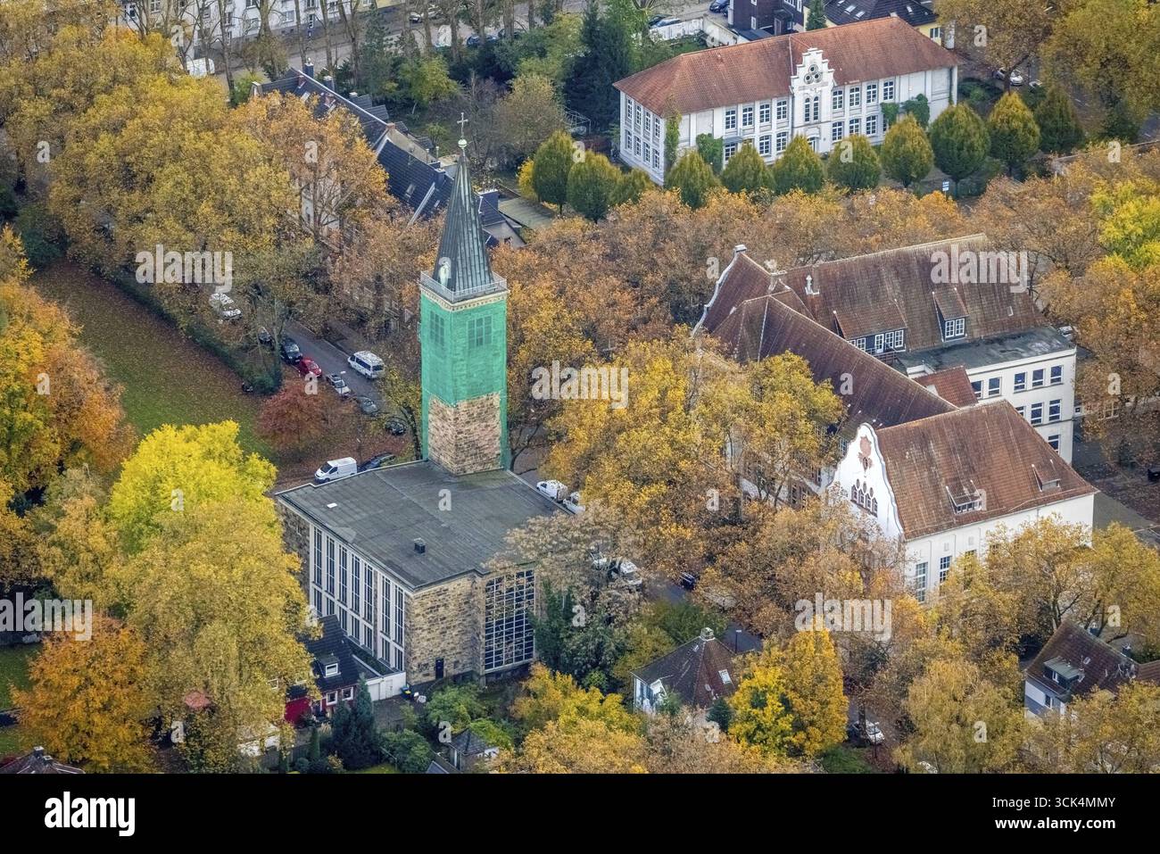 Aus der Vogelperspektive, St. Paul's Church mit überdachtem Kirchturm, Carl-Friedrich-Gauß-Gymnasium und Zweiggebäude, umgeben von herbstlichen Laubbäumen, B Stockfoto