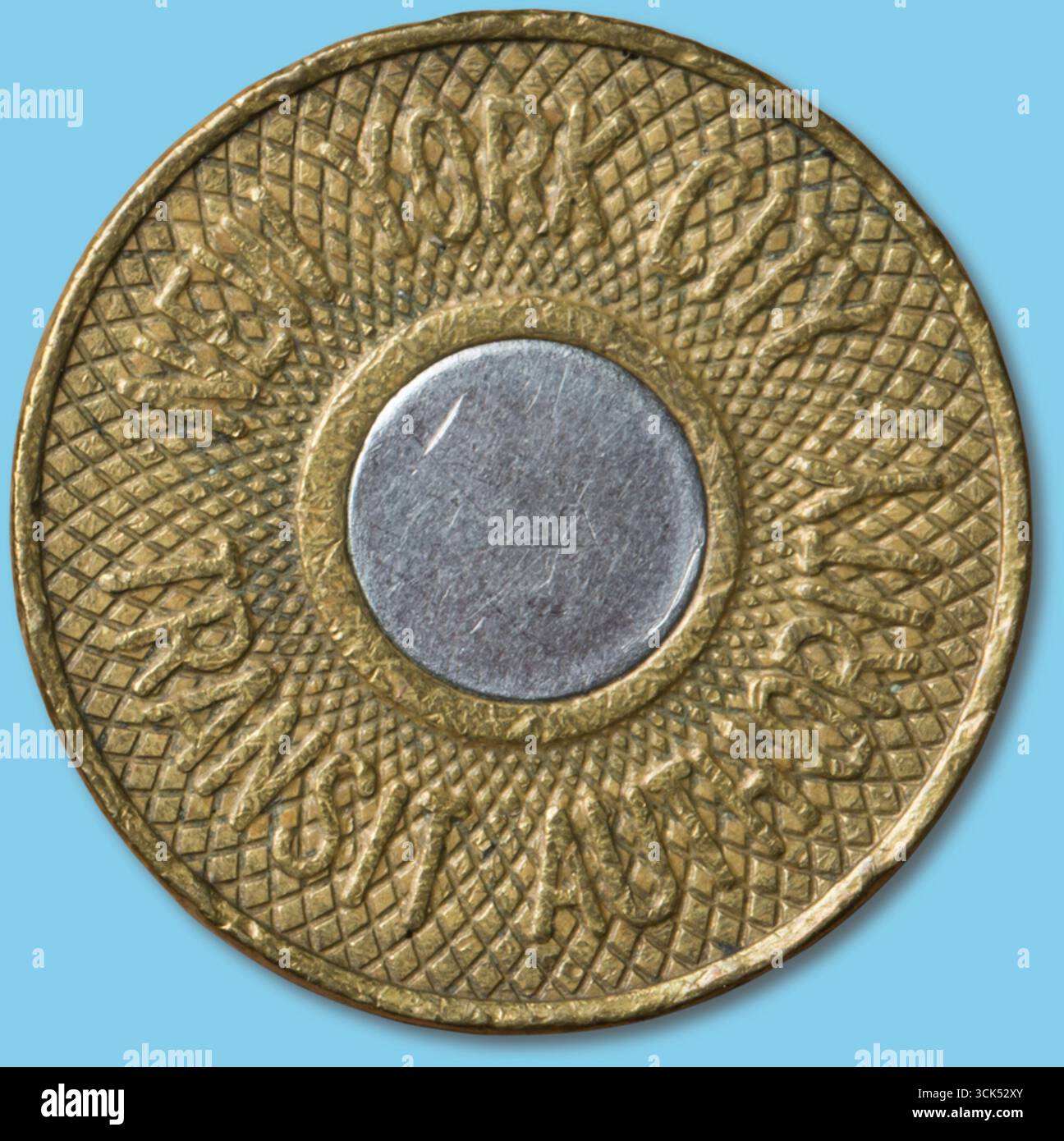 Ein kreisförmiges Zeichen mit strukturiertem Rand und einem zentralen metallischen Kreis, das wahrscheinlich für den Transitzugang in einer Stadt verwendet wird. Stockfoto
