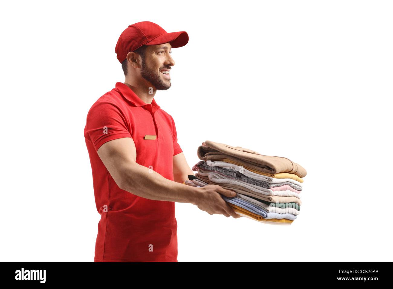 Trockenarbeiter, der einen Stapel gefalteter Kleidung isoliert auf weißem Hintergrund liefert Stockfoto