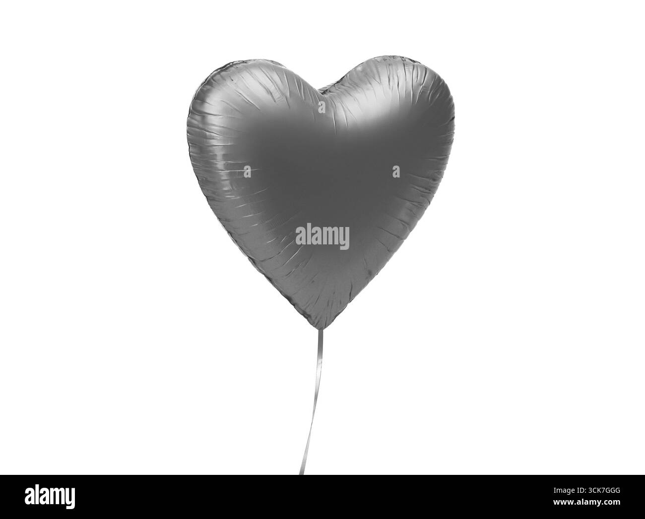 Ein glänzender silberner Ballon in Herzform, der auf einer dünnen Schnur schwebt. Stockfoto