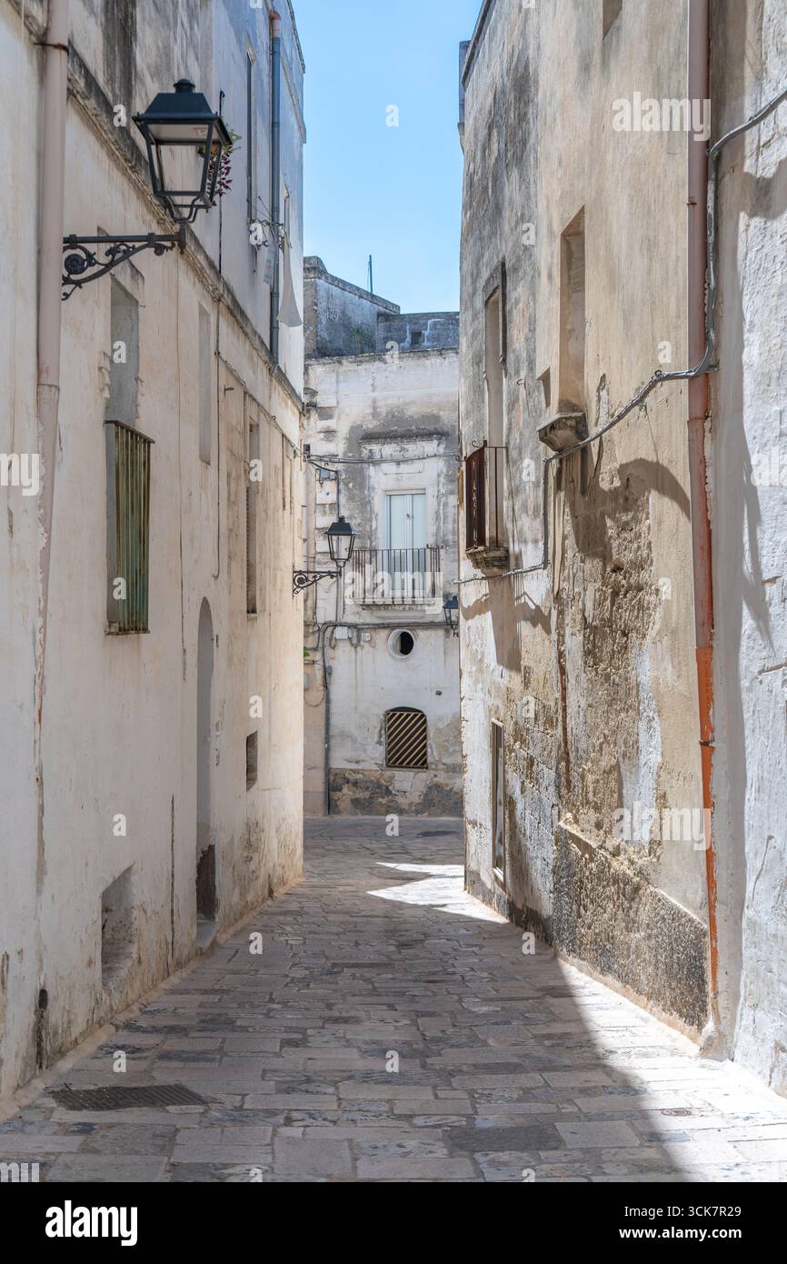 Ein Bild von Gebäuden zwischen Steingassen und mediterranen Balkonen im historischen Zentrum unter blauem Himmel, Süditalien. Grottaglie (Apulien, Italien) Stockfoto