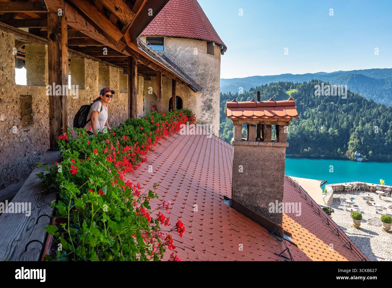 Touristen Frau, die die atemberaubende Aussicht auf den Bleder See von der Burg aus genießt, Slowenien. Stockfoto